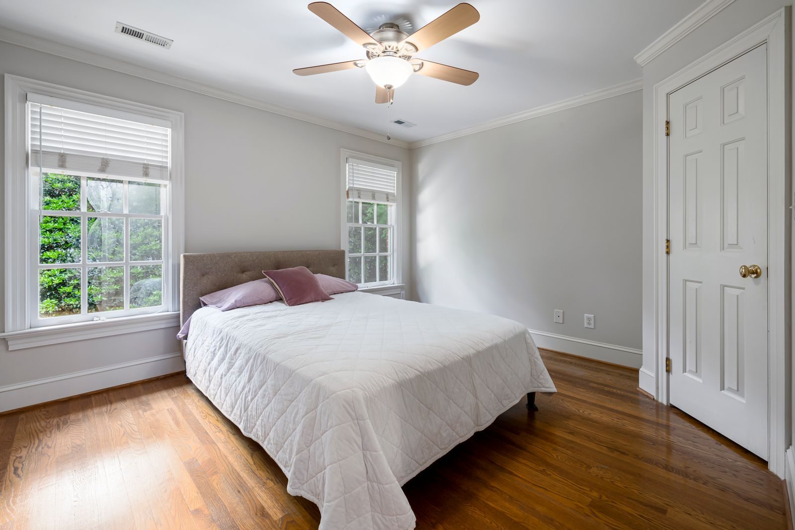 Bright guest bedroom with crisp white bedding, ready for check-in