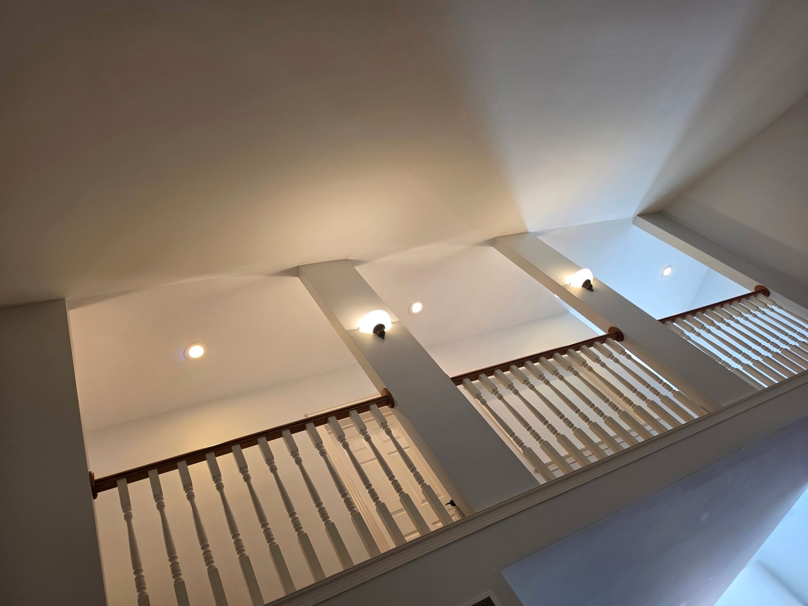 Vaulted ceiling above a tall stairwell in a DeWitt, Michigan home, painted by Exit Strategies Property Solutions