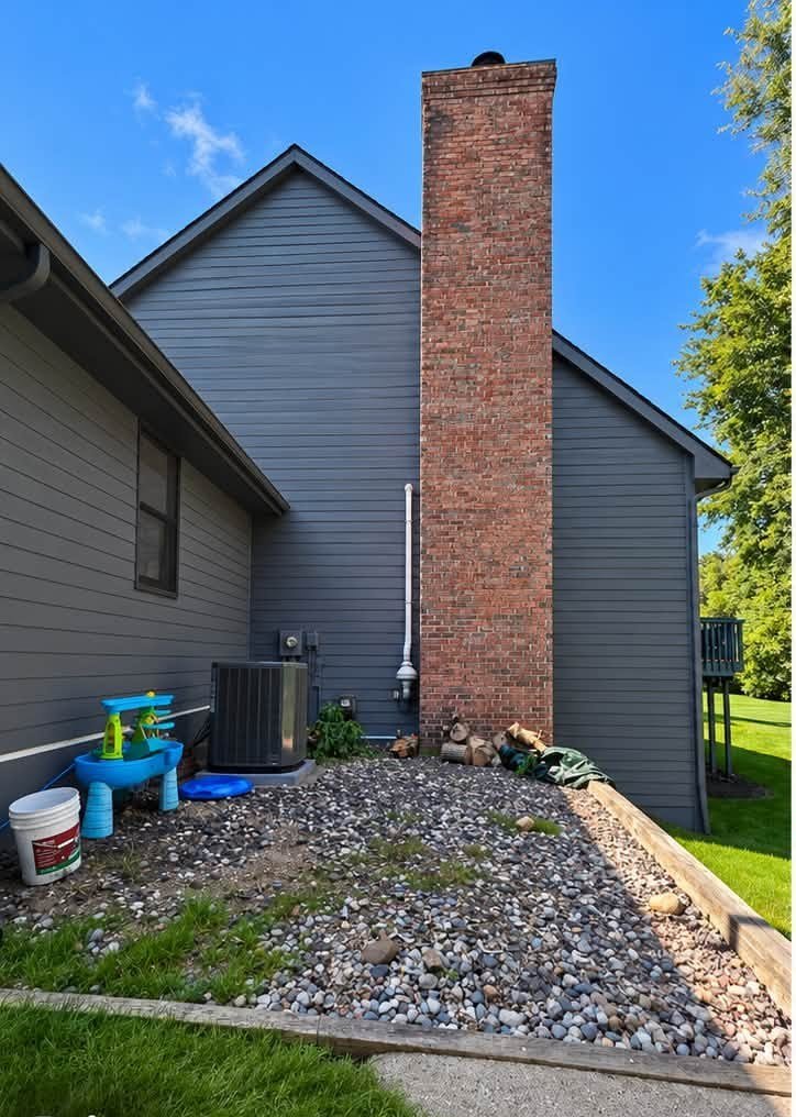 Home exterior before repaint, gray siding