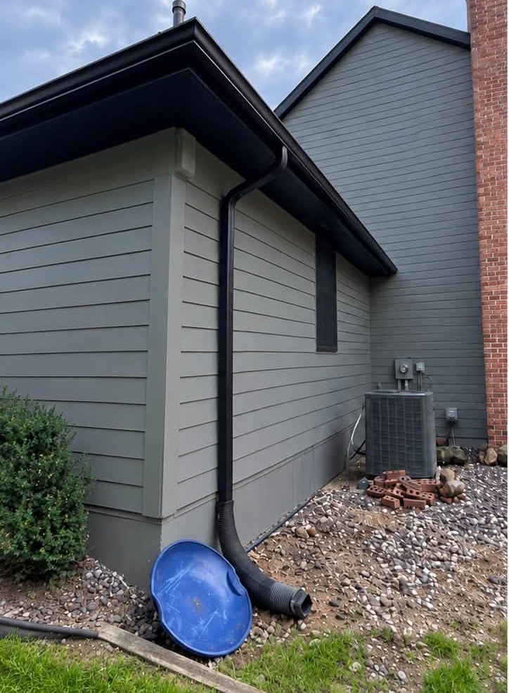 Home exterior before repaint, gray siding