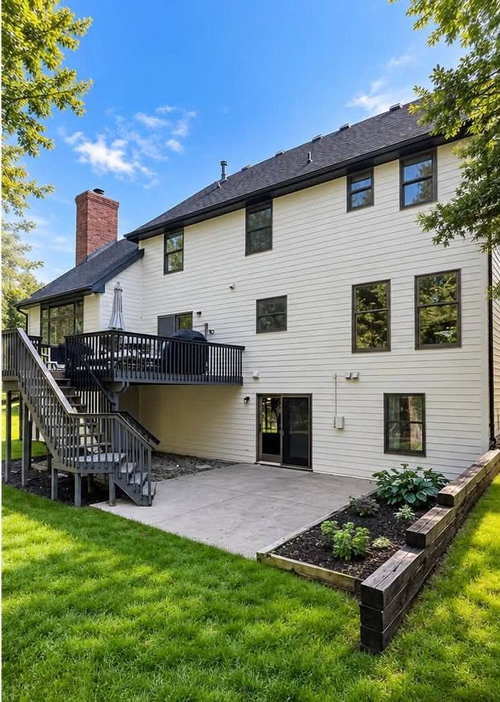 Finished exterior repaint — dark gray siding refinished in bright white