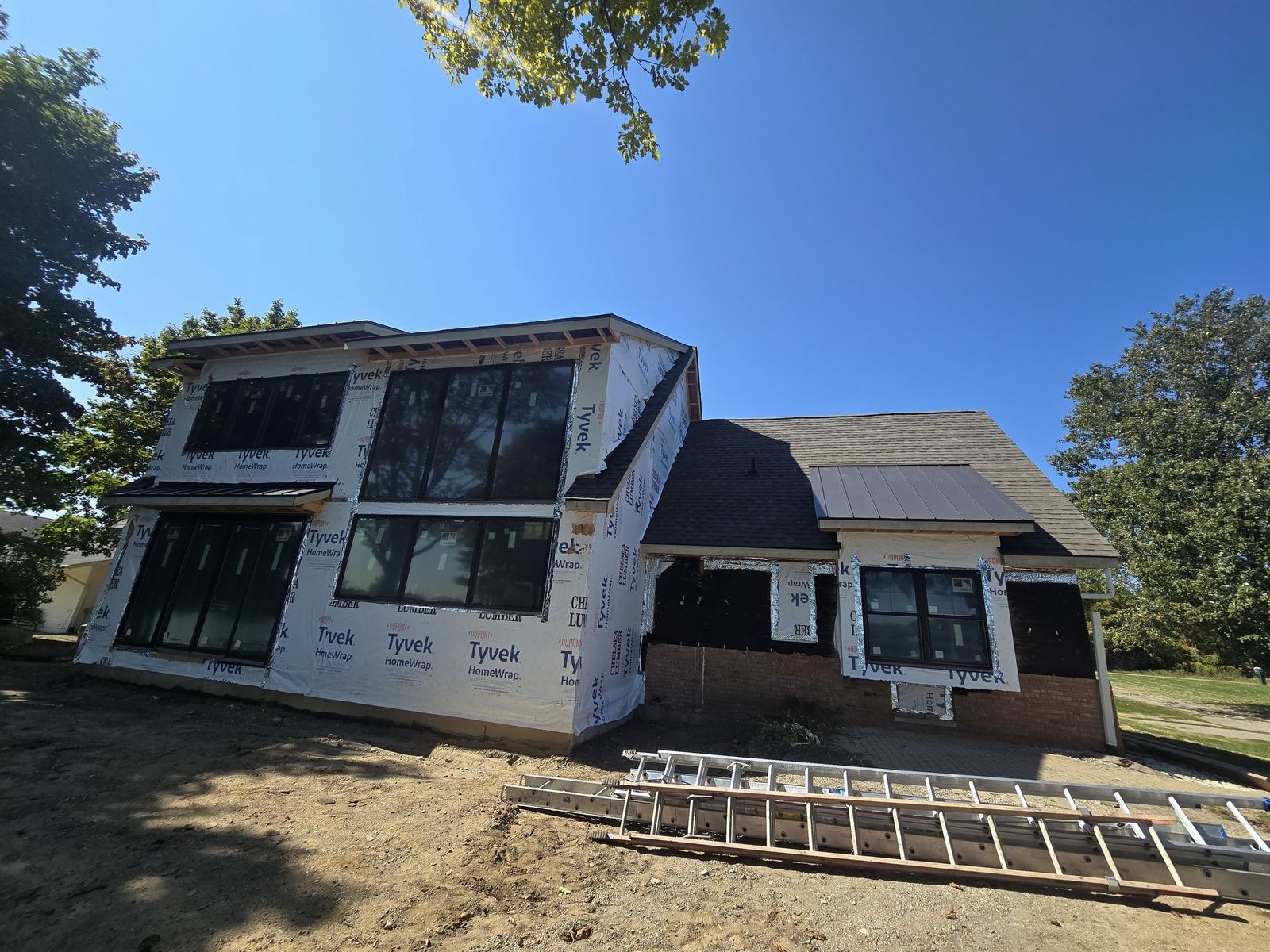 Siding installation in progress on a two-story home
