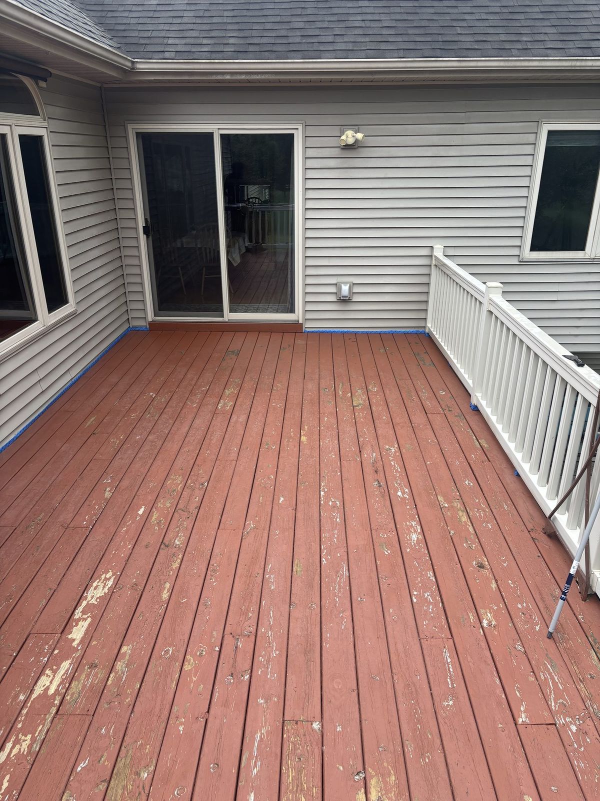 Weathered deck with failing coating before refinishing