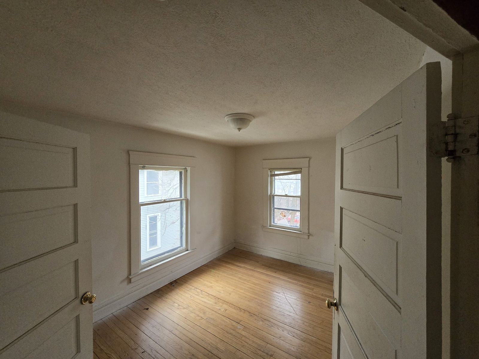 Repainted vacant room with wood floors
